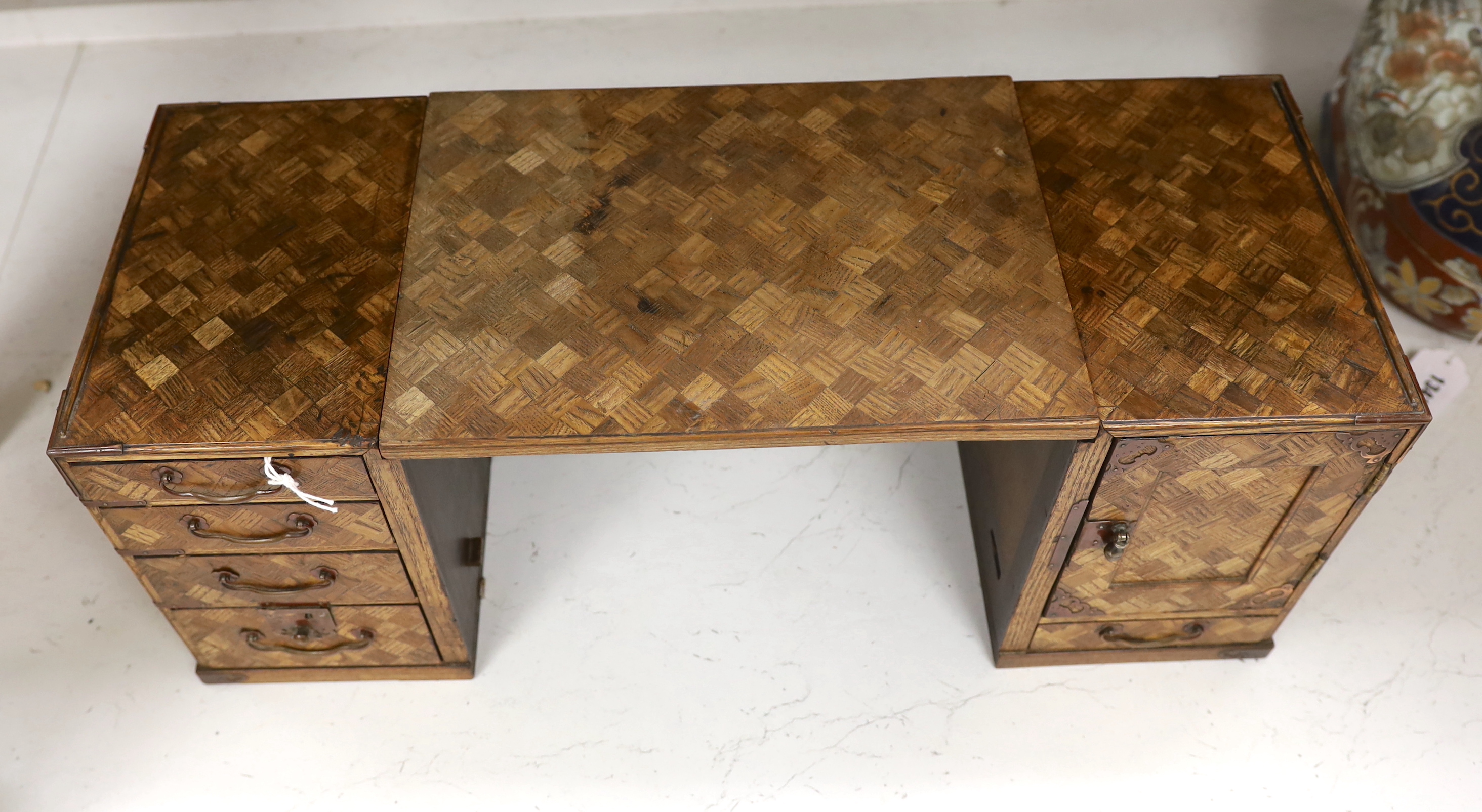 An early 20th century Japanese parquetry table cabinet or scholar's box, 24.5cm high, 63cm wide when extended